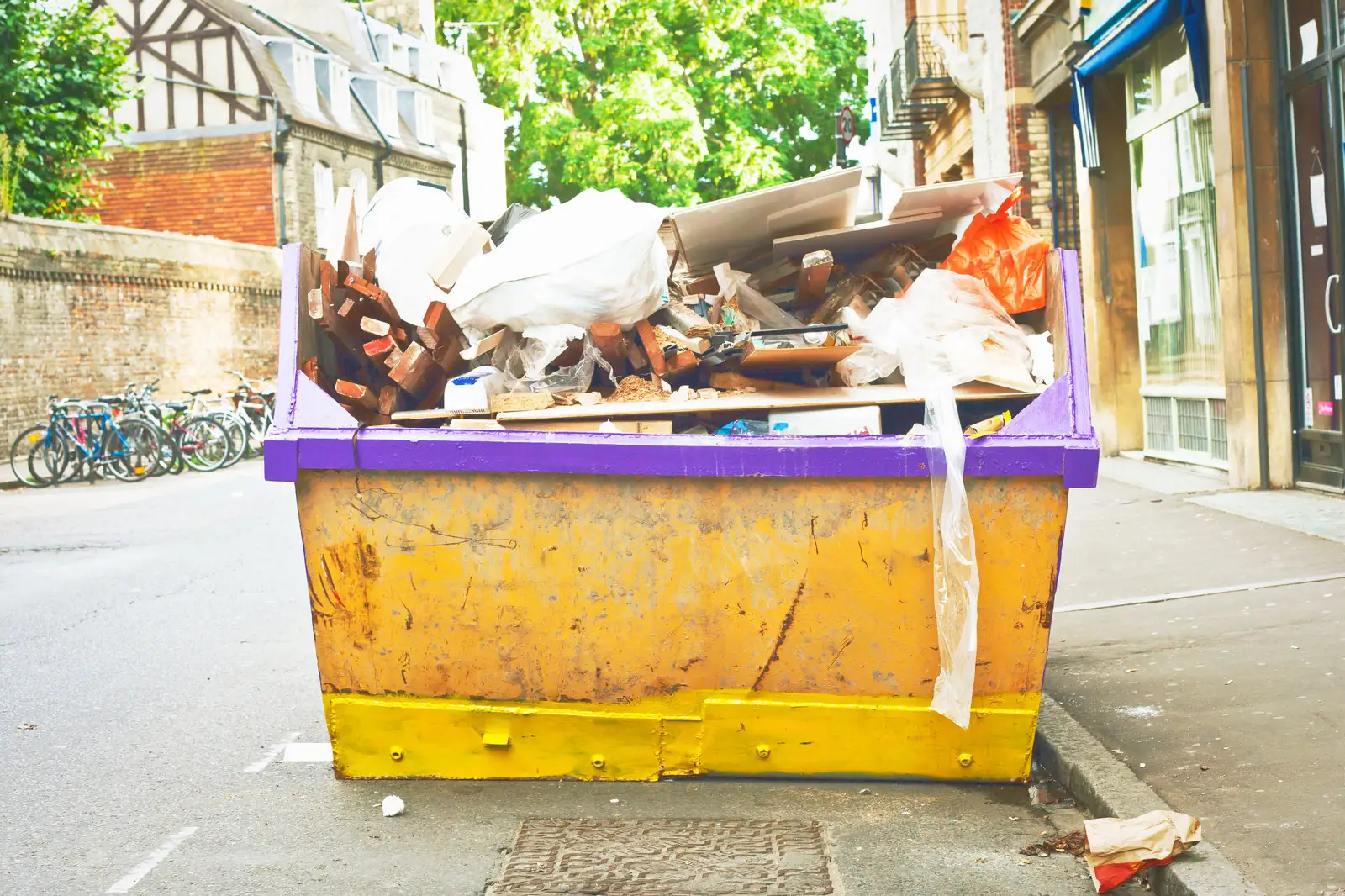 Builders skip full of renovation waste, showing what size skip a project needs
