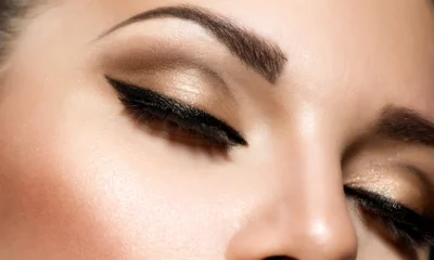 Close-up of eye make-up with winged liner and shimmer shadow