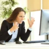 Frustrated woman looking at her computer screen