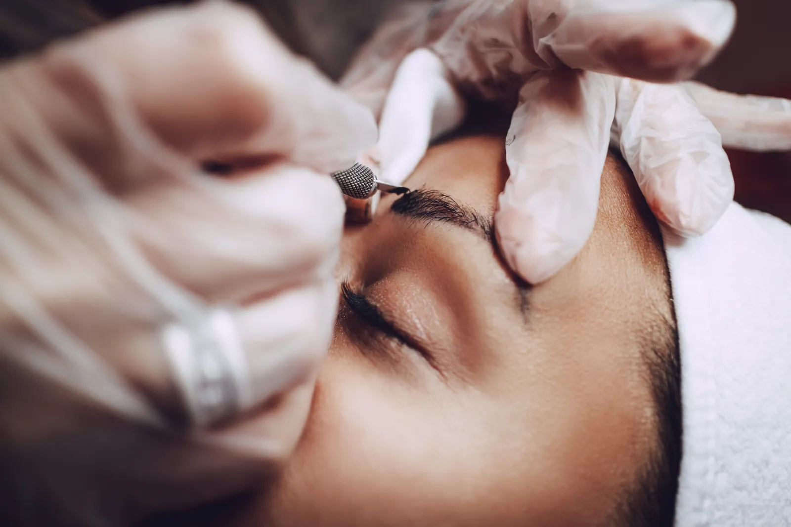 Beautician carrying out a microblading eyebrow treatment