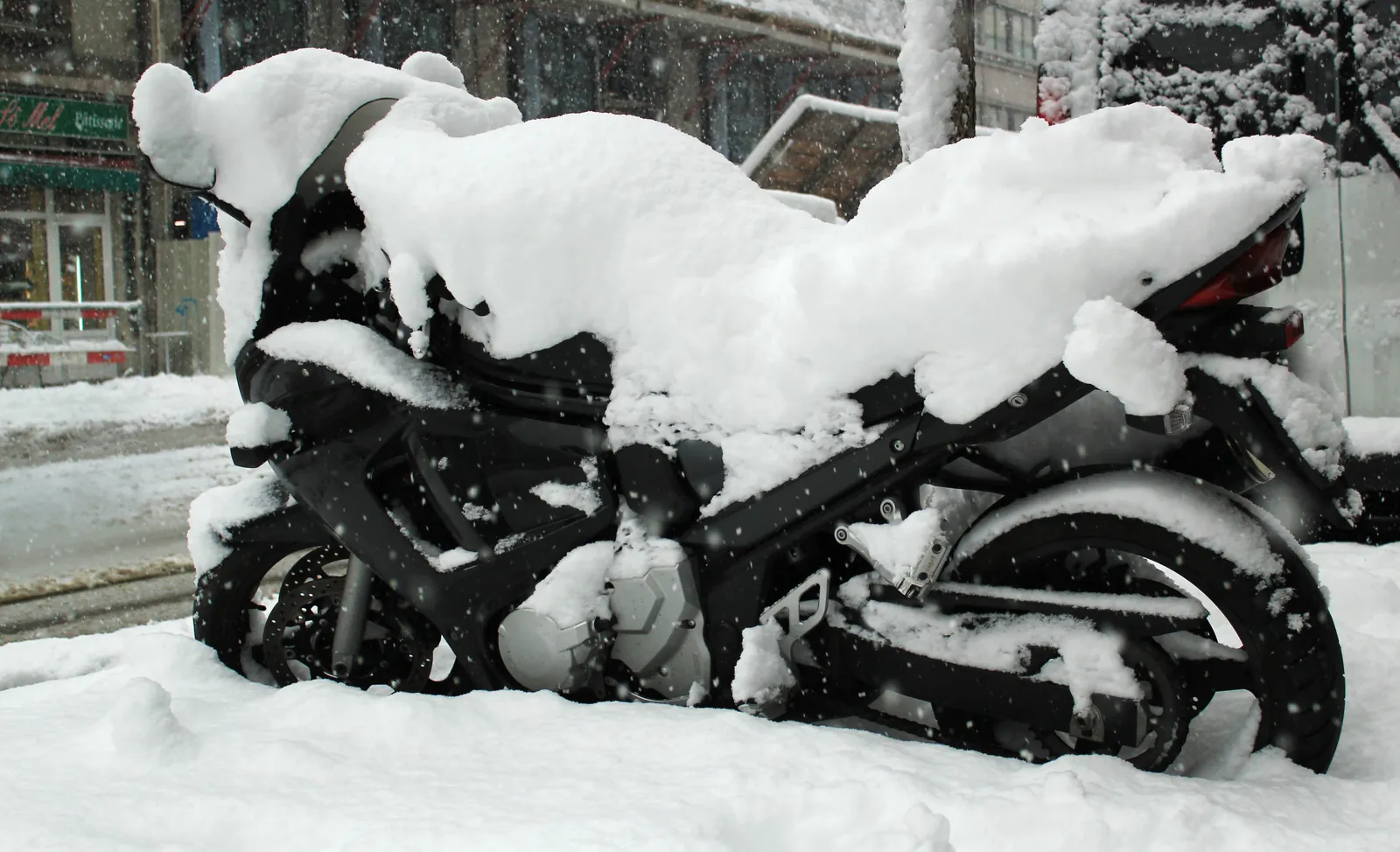 Motorcycle covered in snow