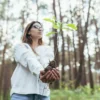 Young oak seedling held in cupped hands, showing how you can grow trees from seed