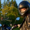 Rider wearing a full-face motorcycle helmet with a clear visor