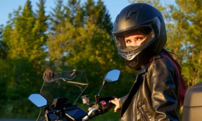 Rider wearing a full-face motorcycle helmet with a clear visor