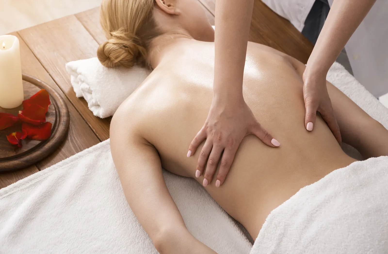 Therapist treating a client's back during a spa treatment