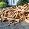 Stacked dried firewood logs outside a house
