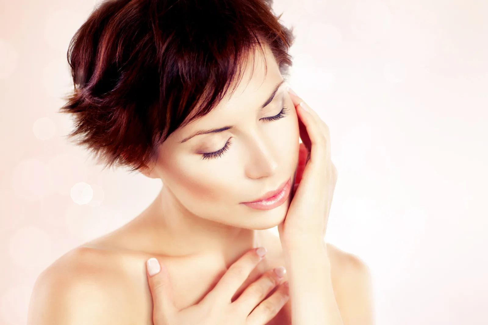 Woman gently touching her face as part of her skincare routine