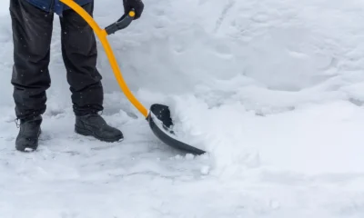 Person clearing heavy snow with a shovel